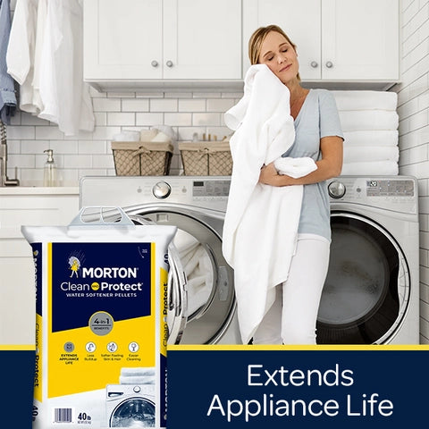 Woman holding a towel next to a washing machine with Morton water softener pellets packaging.